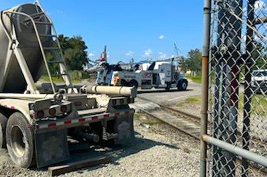 Prompt Towing Service recovering a jack-knifed container truck near the Port of Wilmington using specialized heavy duty wreckers and recovery straps.