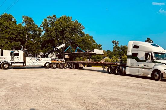 Prompt Towing Service recovering a jack-knifed semi near the Port of Wilmington Main Gate with rotator wreckers and load stabilization.