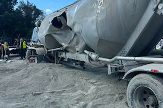 Heavy recovery near Wilmington’s port rail line after a train struck a cement truck. Prompt Towing used twin heavy wreckers and a crane to clear the scene efficiently.