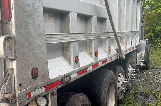 Dump truck being winched from a ditch along US-17 in Supply North Carolina by Prompt Towing Service.
