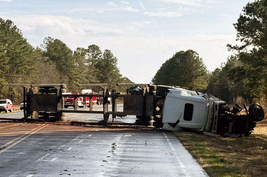 Semi truck overturned blocking roadway in Warsaw NC being cleared by heavy duty towing service